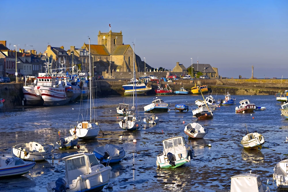 Barfleur, its picturesque port and iconic church overlooking the Normandy coastline, photo chosen by monsieurdefrance.com.